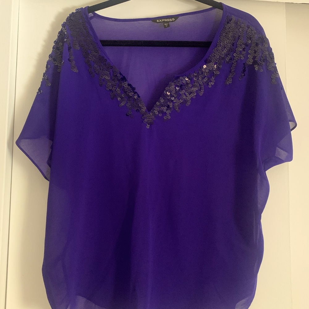 Beautiful sheer flowy purple shirt. Dress it up or dress it down!